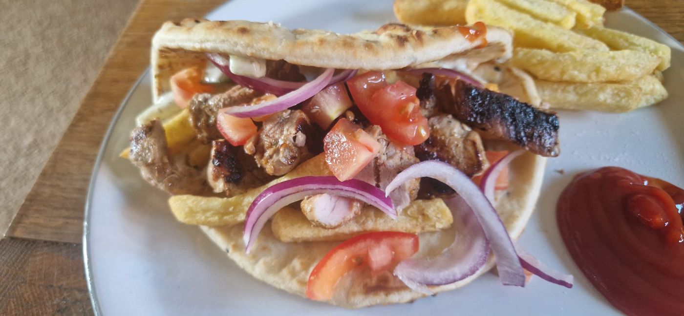 Gyros wrap with tomato, red onion and chips